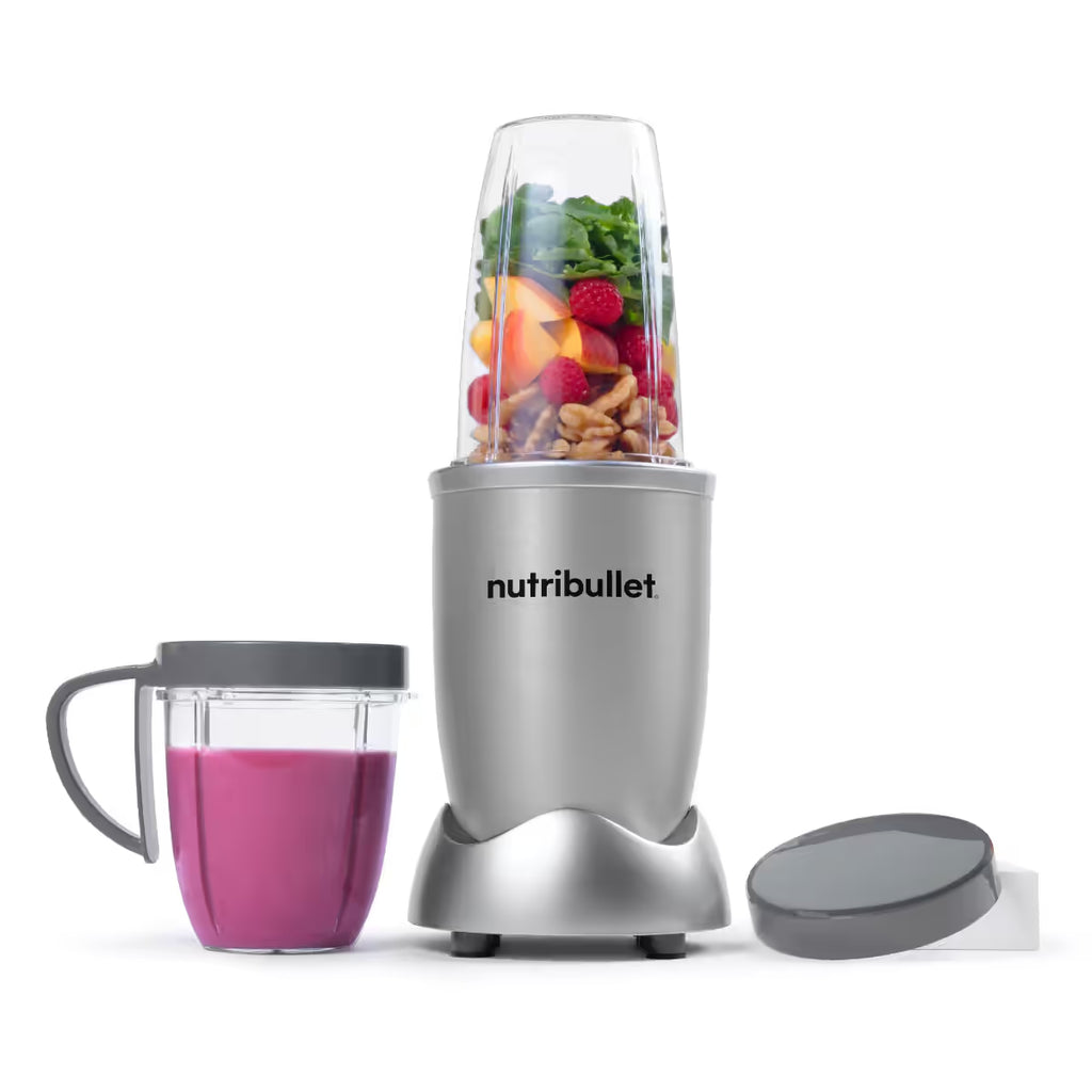 Licuadora personal Nutribullet Original 600W en color plateado con vaso lleno de frutas fresas, batido preparado y tapa sobre fondo blanco - Ferretería La Palma - 1690080