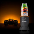 Licuadora personal Nutribullet Pro 900 edición McLaren F1 Team con vaso lleno de frutas y silueta de auto de carreras - Ferretería La Palma - 1690079