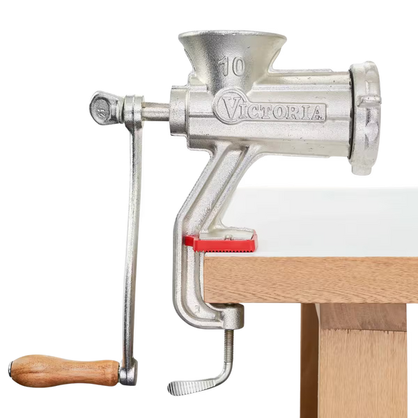 Molino de carne manual Victoria número 10 fabricado en hierro fundido con recubrimiento de estaño, mango de madera ergonómico y prensa de sujeción con protector rojo para mesa - con fondo transparente - Ferretería La Palma - 1440002