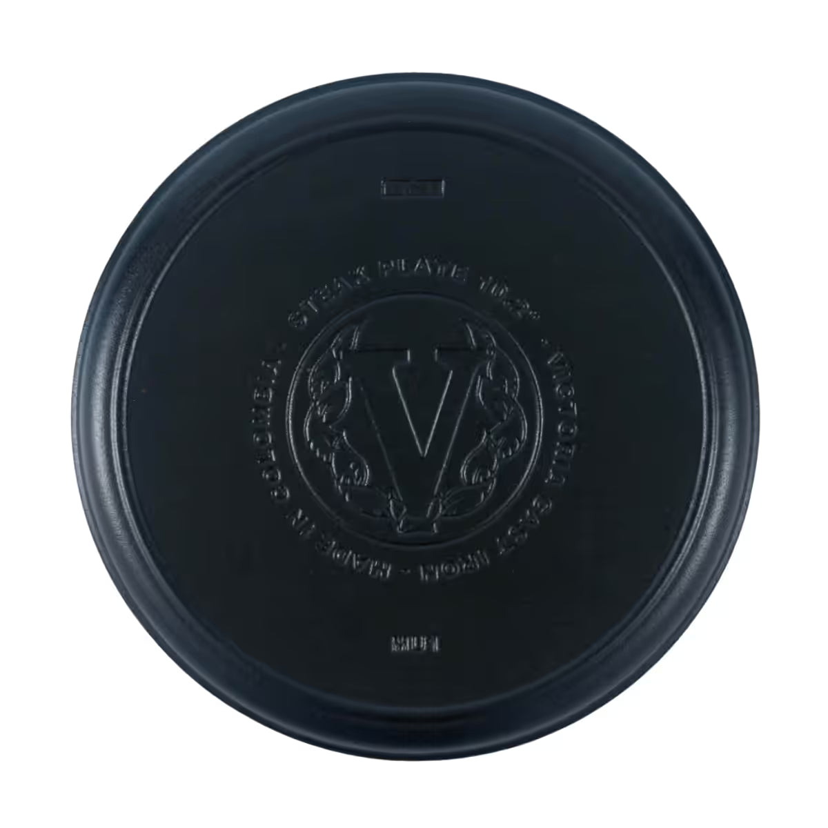 Vista cenital de la parte inferior del plato redondo Victoria de 26 cm en hierro fundido esmaltado con el logo de la marca grabado - Ferretería La Palma - 1050037